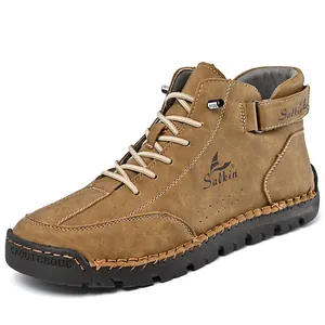 Detail view of brown high-top men's leather Martin boots featuring hand-stitched sole