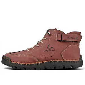 Detailed side view of brown handmade stitched leather Martin boots for men with rubber sole.