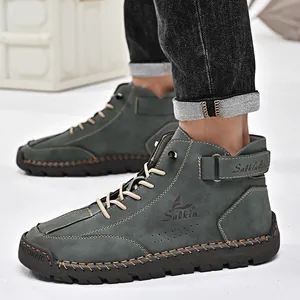 Side detail view of durable hand-stitched men's outdoor Martin boots in premium dark grey leather