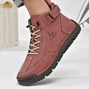 Detail view of men's reddish-brown leather Martin boot featuring hand-stitched sole.