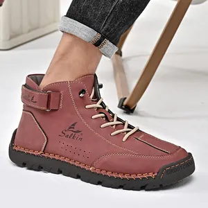 Side detail of men's hand-stitched high-top leather Martin boots in reddish-brown