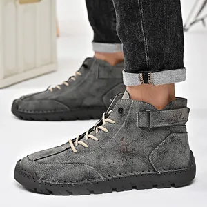 Detailed side view of hand-stitched grey leather high-top outdoor Martin boots