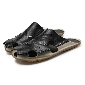 Detailed view of men's black leather closed-toe sandals with perforated design