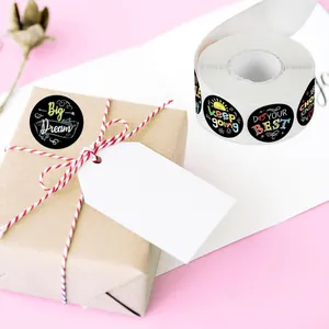 Roll of motivational reward stickers with 'Big Dream' text on gift box packaging view.