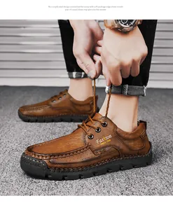 Close-up detail of hand-stitched brown leather casual men's shoes featuring laces