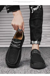 Close-up of hand-stitched black men's casual leather shoes with lace-up detail.