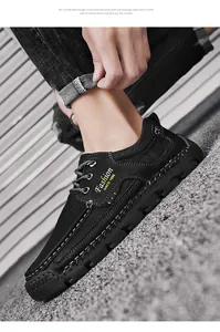 Detailed view of hand-stitched black leather casual shoes for men worn by a model