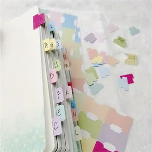 Close-up of colorful writable index tabs used on a notebook for organization
