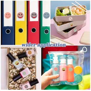 Detailed view of multi-colored cartoon smiley face stickers applied to household items
