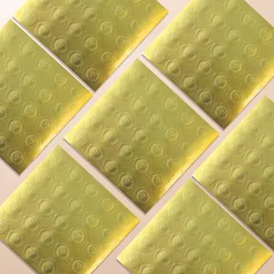 Detailed view of gold embossed heart-shaped stickers for elegant wedding invitations