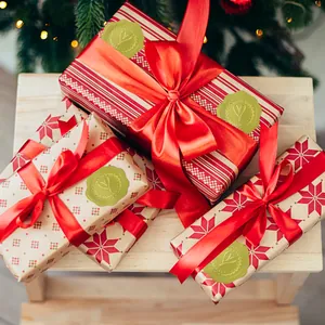 Detail view of gold heart embossed stickers used as festive gift box seals.