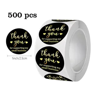 Detail view of 1-inch black and gold foil thank you stickers showing size and quantity.
