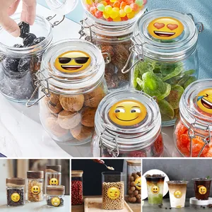 Close-up of creative funny emoji stickers used for decorating food storage glass jars
