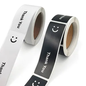 Close-up of black and white rectangular stickers with smiley face and Thank You text