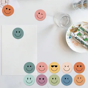 Variety of muted colored smiley face reward stickers for children's praise
