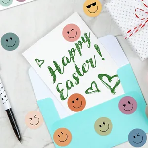Macro shot of colorful smile face reward stickers decorating an Easter card envelope.