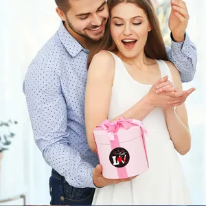 Romantic Valentine's Day heart stickers shown on a pink cylindrical gift box for a couple.