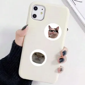 Close-up of funny cat meme stickers applied on a cream phone case for decoration