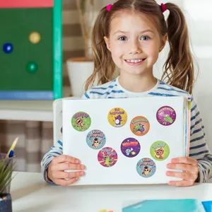 Detail of colorful animal reward stickers with Spanish motivational text on sketchbook