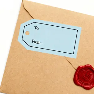 Detail of blue self-adhesive gift tag with To and From on brown envelope