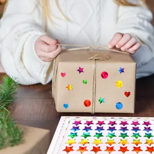 Holographic star stickers on a brown gift box for creative DIY children decoration.