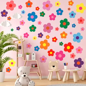 Colorful flower wall stickers decorating a pink nursery room wall with cute props