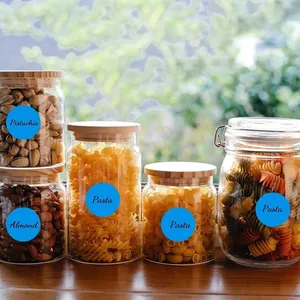 Étiquettes adhésives circulaires bleues sur des bocaux pour l'organisation de la cuisine.