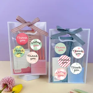 Detailed view of colorful round 'Thank you' stickers used on transparent gift bags