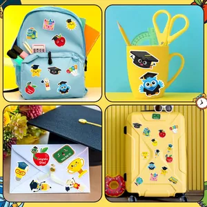Graduation stickers displayed on backpack, mug, envelope and suitcase