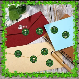 Festive St. Patrick's Day shamrock stickers applied to colorful envelopes for mailing.