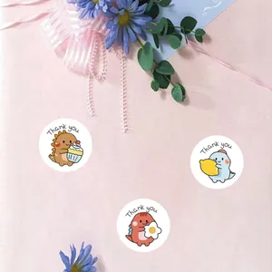Detail showing cute cartoon dinosaur reward stickers with hand-written Thank You text
