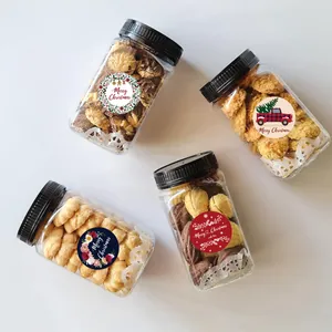 Set of four cookie jars decorated with festive round Merry Christmas sealing stickers