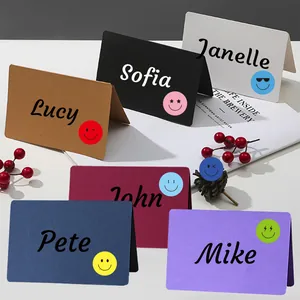 Close-up of colorful emoji smiley face stickers applied to various decorative place cards