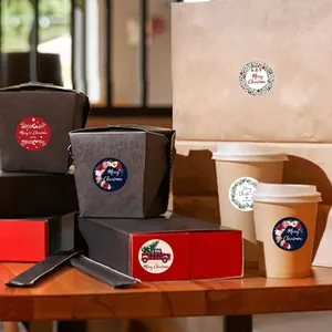 Close-up of Christmas stickers applied to cups and gift boxes for holiday packaging