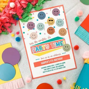 Detail of colorful smiley face emoji stickers used for birthday party invitation decor.