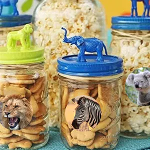 Detailed macro view of round jungle animal stickers applied on party favor glass jars