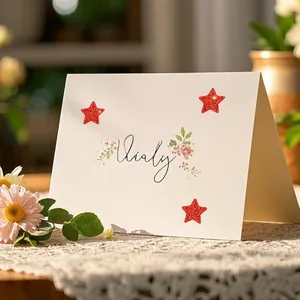 Decorative red glitter star reward stickers applied to a cream-colored greeting card