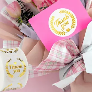 Pegatinas Thank You doradas en tarjeta rosa, ideales para bodas o empaques de regalo.