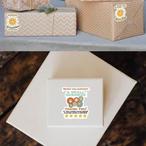 Close-up showing colorful daisy flower thank you stickers used on wrapped gift boxes