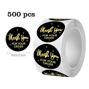 Close-up detail of 1-inch black and gold foil thank you stickers, 500 pieces per roll.