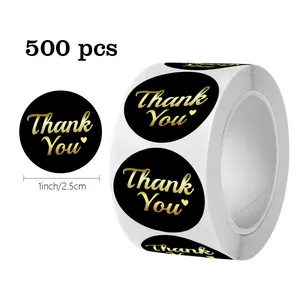 Detail showing 500pcs of 1 inch black and gold foil Thank You stickers on a roll