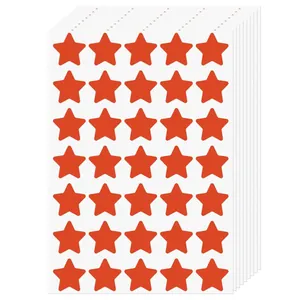 Macro view of multiple sheets of stacked red star-shaped reward stickers for student encouragement.