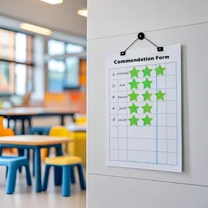 Green glitter star stickers applied to a classroom commendation chart for student rewards