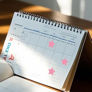 Macro view of pink star reward stickers applied on a desk planner for daily motivation