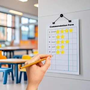 Close-up of yellow star reward stickers on a classroom commendation chart