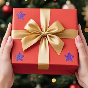 Detailed view of purple glitter star stickers applied to a red holiday gift box.