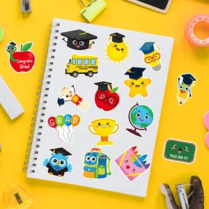 Detailed view of colorful cartoon graduation stickers on a notebook with school supplies