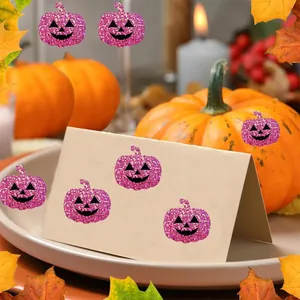 Glittering purple pumpkin stickers decorating a cream card for Halloween party DIY