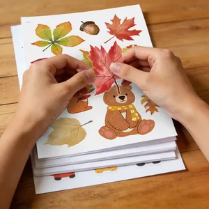 Applying autumn maple leaf static window stickers with a cute cartoon bear design for decor