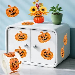 Detail view of laser pumpkin stickers on a roll and applied to white furniture.